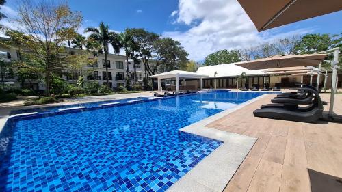 a swimming pool with a slide in a building at PonteFino Hotel in Batangas City