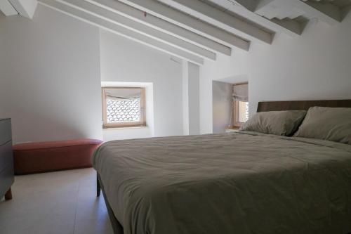 a bedroom with a large bed and a window at Vicolo dei Signori By Case al Lago in Desenzano del Garda