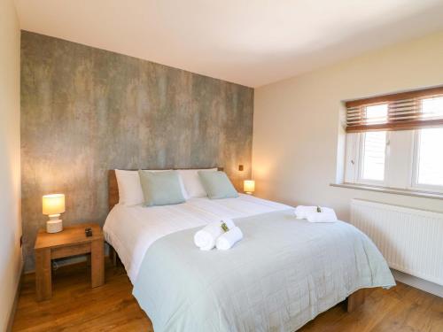 a bedroom with a large bed with towels on it at Cherry Tree Farm in Chesterfield