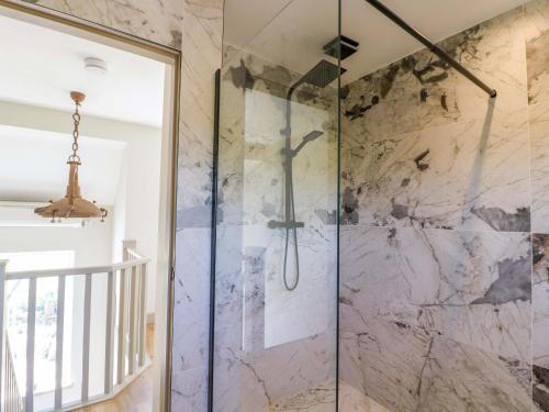 a walk in shower with a glass door at Cherry Tree Farm in Chesterfield