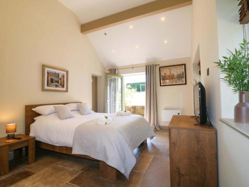 a bedroom with a bed and a tv in a room at Cherry Tree Farm in Chesterfield