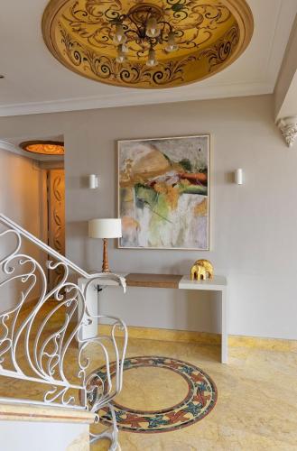 a living room with a ceiling with a chandelier at VESTA - Nile Zamalek Residence in Cairo