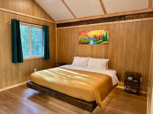 a bedroom with a bed in a wooden wall at Roberts Lodge in Tok