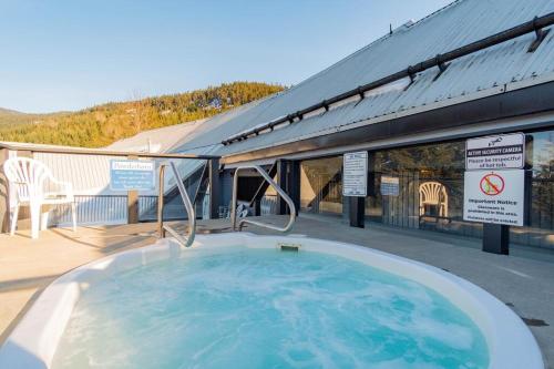 a large hot tub on the deck of a building at Powderhorn by Whistler Blackcomb Vacation Rentals in Whistler