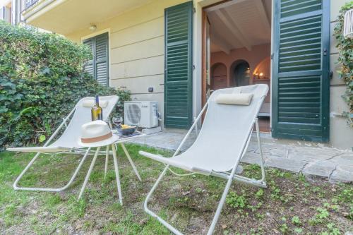 two chairs and a hat sitting outside a house at OC Lake Love by Rent All Como in Laglio