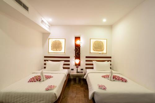 Ένα ή περισσότερα κρεβάτια σε δωμάτιο στο Angkor Breeze Hotel & Spa