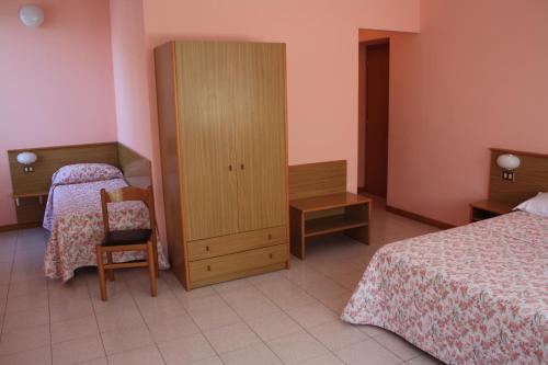 Ένα ή περισσότερα κρεβάτια σε δωμάτιο στο Hotel Vapore
