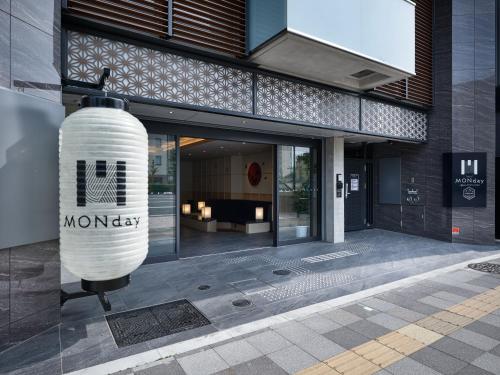 a building with a sign on the side of it at Premium Apart MONday KYOTO GOJO in Kyoto