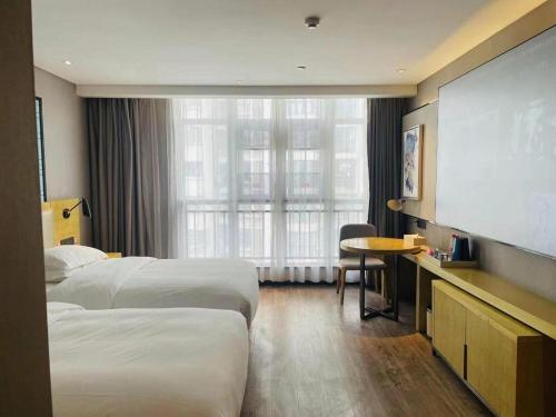 Ένα ή περισσότερα κρεβάτια σε δωμάτιο στο Echarm Hotel Huangshi Yingbin Avenue
