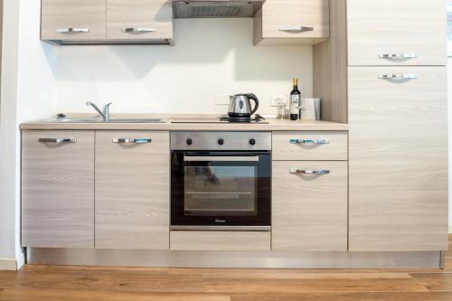 a kitchen with a stove and a sink at Carpione By Case al Lago in Desenzano del Garda