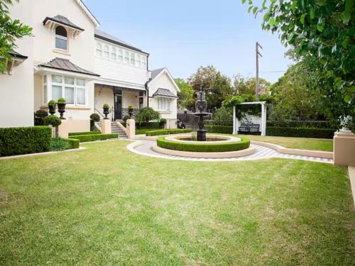 a house with a fountain in the middle of a yard at Inner-West Studio in a Perfect Location in Sydney