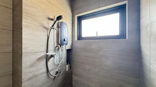 a shower in a bathroom with a window at Amber 2Rooms 6pax Quayside Mall Cinema in Teluk Panglima Garang