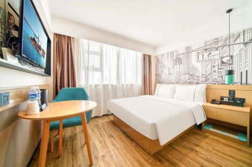 a hotel room with a bed and a table at City Comfort Inn Kunshan High-speed Railway Station Renmin Road in Kunshan
