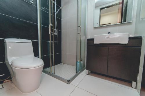 a bathroom with a toilet and a shower and a sink at Danga Bay Coastal Comfort 3BR 8Pax w 3Balcony by Our Stay in Johor Bahru