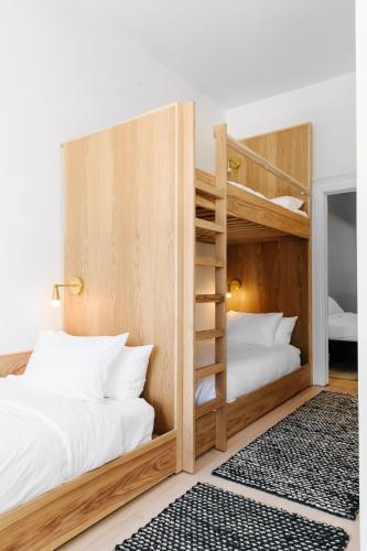 a bedroom with two bunk beds and a rug at The Wyman Hotel in Silverton