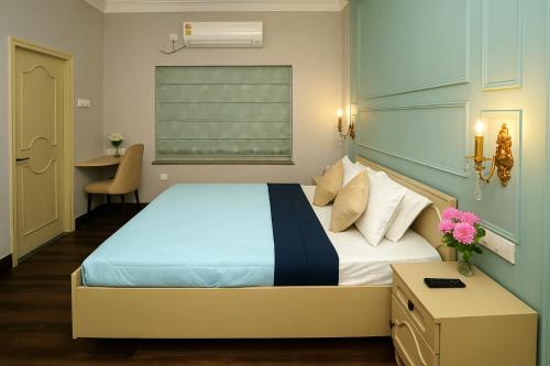 a bedroom with a bed and a desk and a window at City Haven by JadeCaps2BHKAlipore in Kolkata