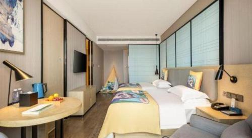 a bedroom with a large white bed and a couch at Echarm Hotel Nanning the MixC Dongmeng Business District in Nanning