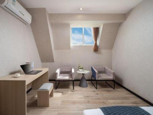 a room with two chairs and a table and a window at Borrman Hotel Yuxi Yuxing Road in Yuxi