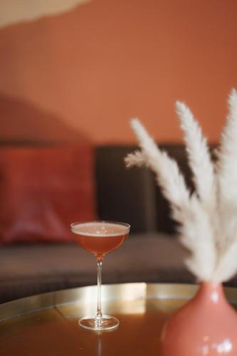 a martini glass sitting on a table with a vase at The Wyman Hotel in Silverton