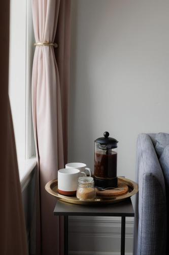a table with a tray of food on it next to a window at The Wyman Hotel in Silverton