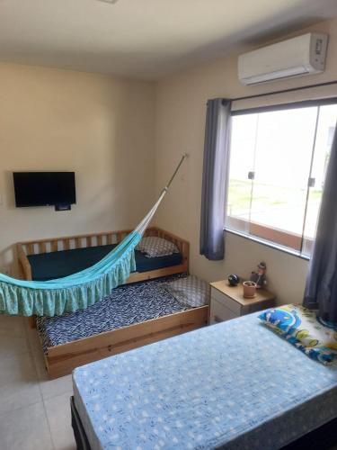 a room with two beds and a hammock in it at Casa Ampla COP30 in Belém