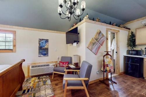 a living room with two chairs and a table at Blitzen - Reindeer Ranch at Round Top in Carmine