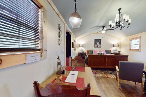 a living room with a table and a couch at Blitzen - Reindeer Ranch at Round Top in Carmine