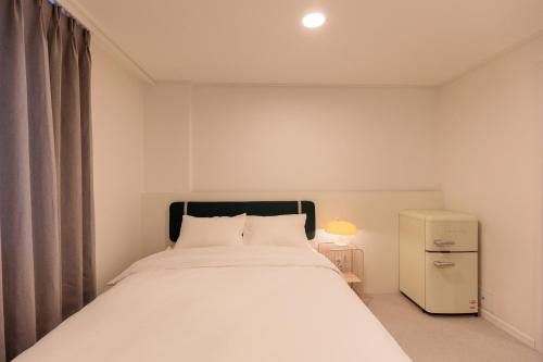 a bedroom with a large white bed in a room at Wecostay Cheongnyangni in Seoul