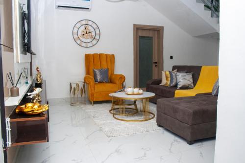 a living room with a couch and a table at Lexanni Havens in Lagos