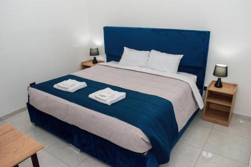 a bedroom with a blue bed with two towels on it at PAQARIY Hs in Arequipa