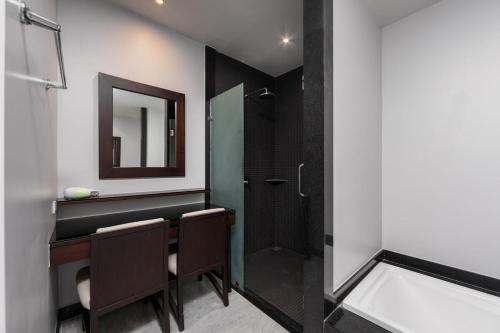 a bathroom with a shower and a vanity with a mirror at VILLA ATA | Private Pool | Saiyuan Estate by Tropiclook | Nai harn beach in Nai Harn Beach