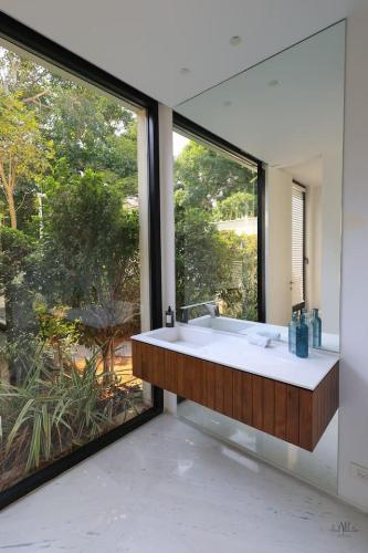 a large bathroom with a tub and a large window at Breathtaking Villa w Pool & Sauna Near the Beach by Sea N' Rent in Herzelia 