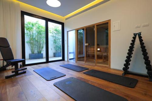 a room with three yoga mats and a chair in a room at Breathtaking Villa w Pool & Sauna Near the Beach by Sea N' Rent in Herzelia 