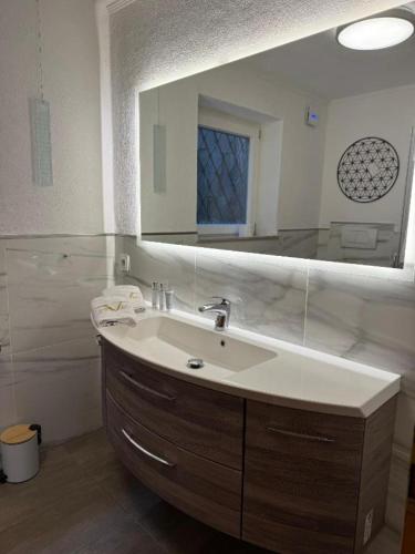 a bathroom with a sink and a mirror at Ferienwohnung Donaublick in Passau