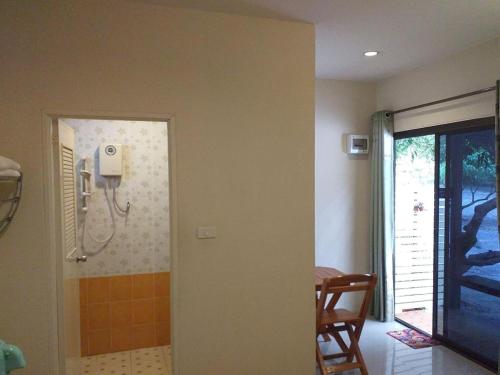 a bathroom with a shower and a phone on the wall at Raisubsomboon Resort in Ban Don Wan