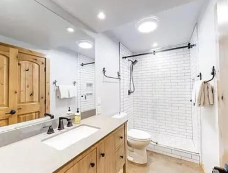 a bathroom with a toilet and a sink and a shower at Streamside Townhome in Kings Beach