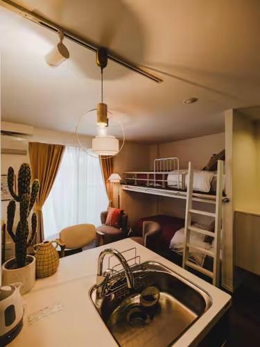 a kitchen with a sink and a bunk bed at OPEN SALE! Stylish Stay near AKIHABARA! May2025 Open! 秋葉原 CORE HOTEL in Tokyo