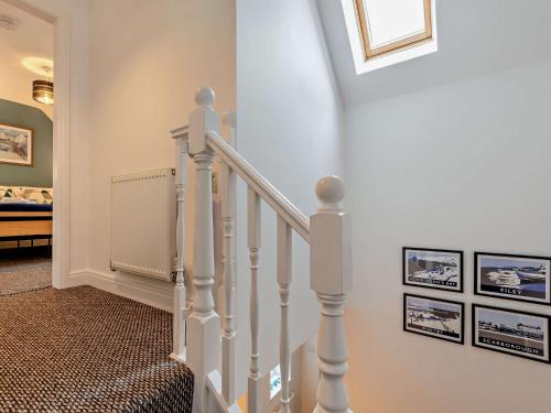 a staircase with white railings in a home at 2 Bed in Filey 89281 in Hunmanby