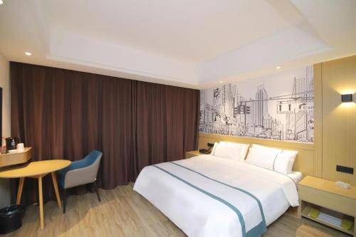 a hotel room with a large bed and a table at City Comfort Inn Changsha Sifangping University of National Defense Science and Technology in Changsha