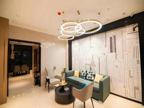 a living room with a couch and chairs and a chandelier at City Comfort Inn Changsha Sifangping University of National Defense Science and Technology in Changsha