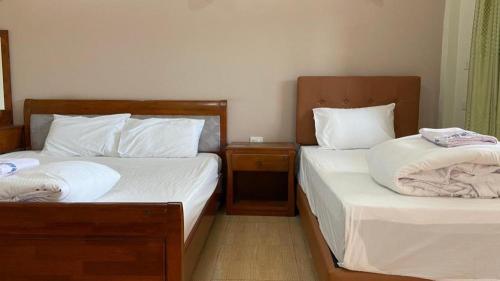 Ένα ή περισσότερα κρεβάτια σε δωμάτιο στο Prakaithong hotel