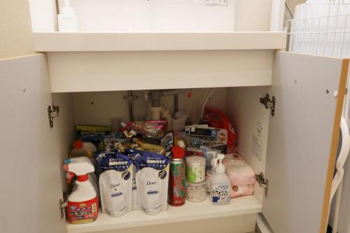 a pantry filled with milk and other food items at blue sea and house in Nanjo