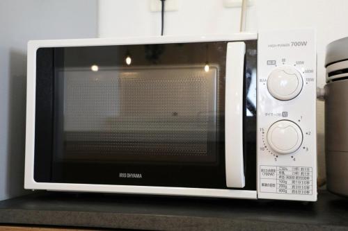 a microwave oven sitting on top of a counter at blue sea and house in Nanjo