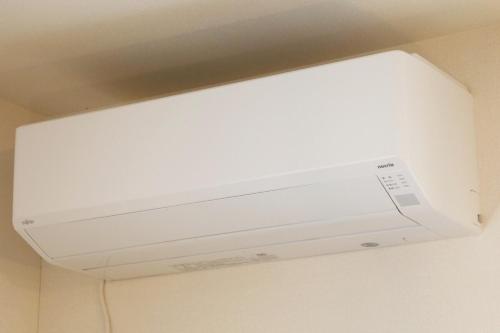 a white overhead light hanging from a ceiling at blue sea and house in Nanjo