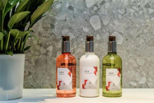 a group of three bottles sitting on a table at Borrman Hotel Chongqing Bishan Central Street in Chongqing