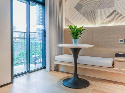 a table with a plant on it in a room at Borrman Hotel Chongqing Bishan Central Street in Chongqing