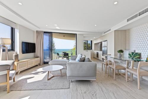 a living room with a couch and a table at Breeze Mooloolaba (APT 503) in Mooloolaba