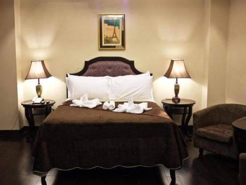 a hotel room with a bed with towels on it at Peridot Suites in Buhangin