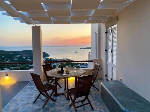 a dining room with a table and a view of the ocean at VILLA NOVA Leros in Drymonas