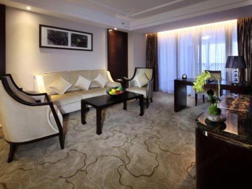 a living room with a couch and a table at SUN Yat-sen university Hotel and Conference Centre in Guangzhou
